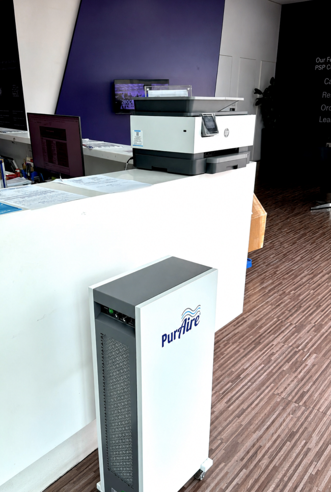 PurAire Ultra-2 bipolar ioniser installed in a hotel lobby beside a reception desk